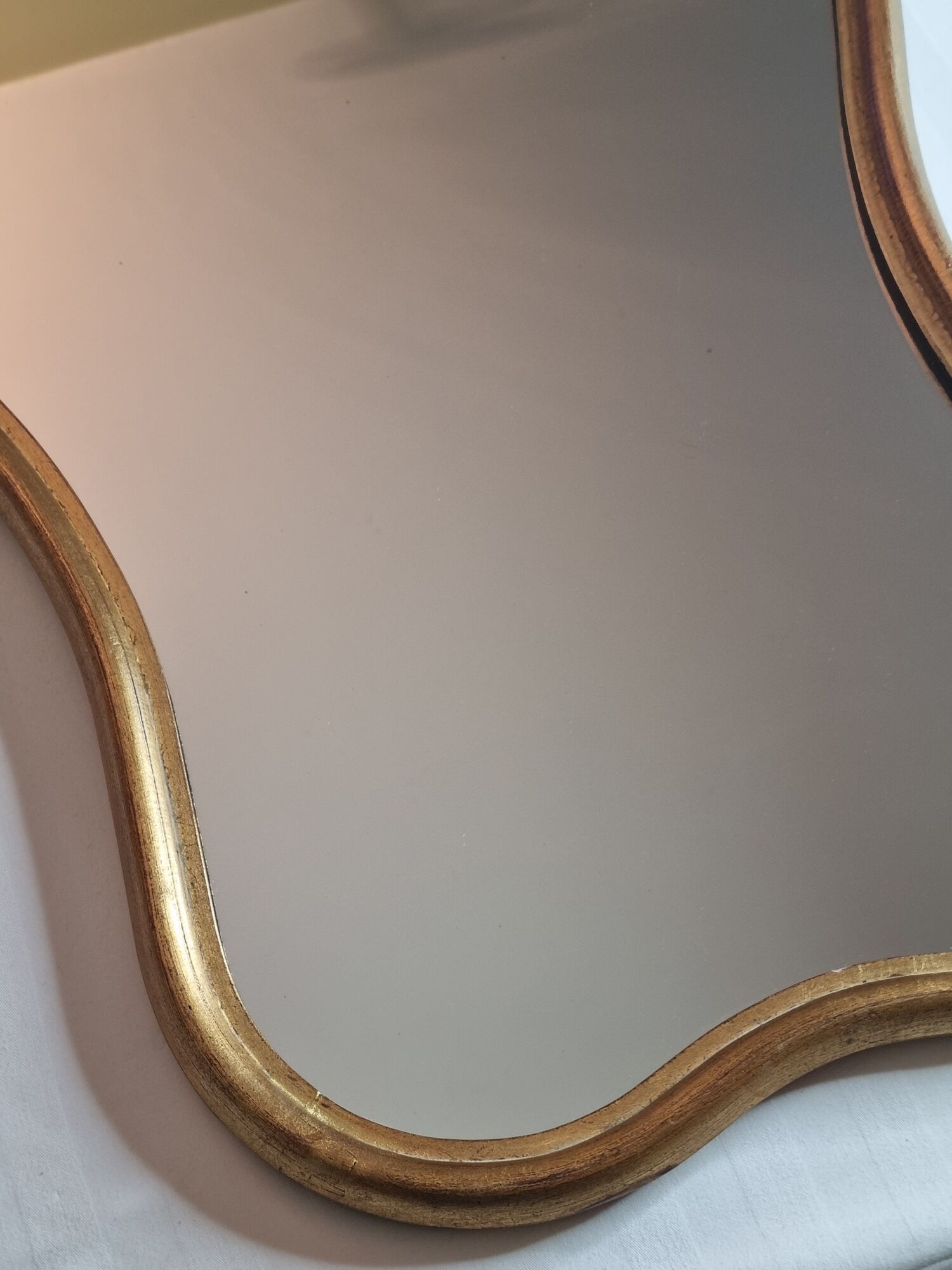 Vintage baroque style mirror, with curved frame in stucco and gilded wood 57 cm