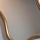 Vintage baroque style mirror, with curved frame in stucco and gilded wood 57 cm