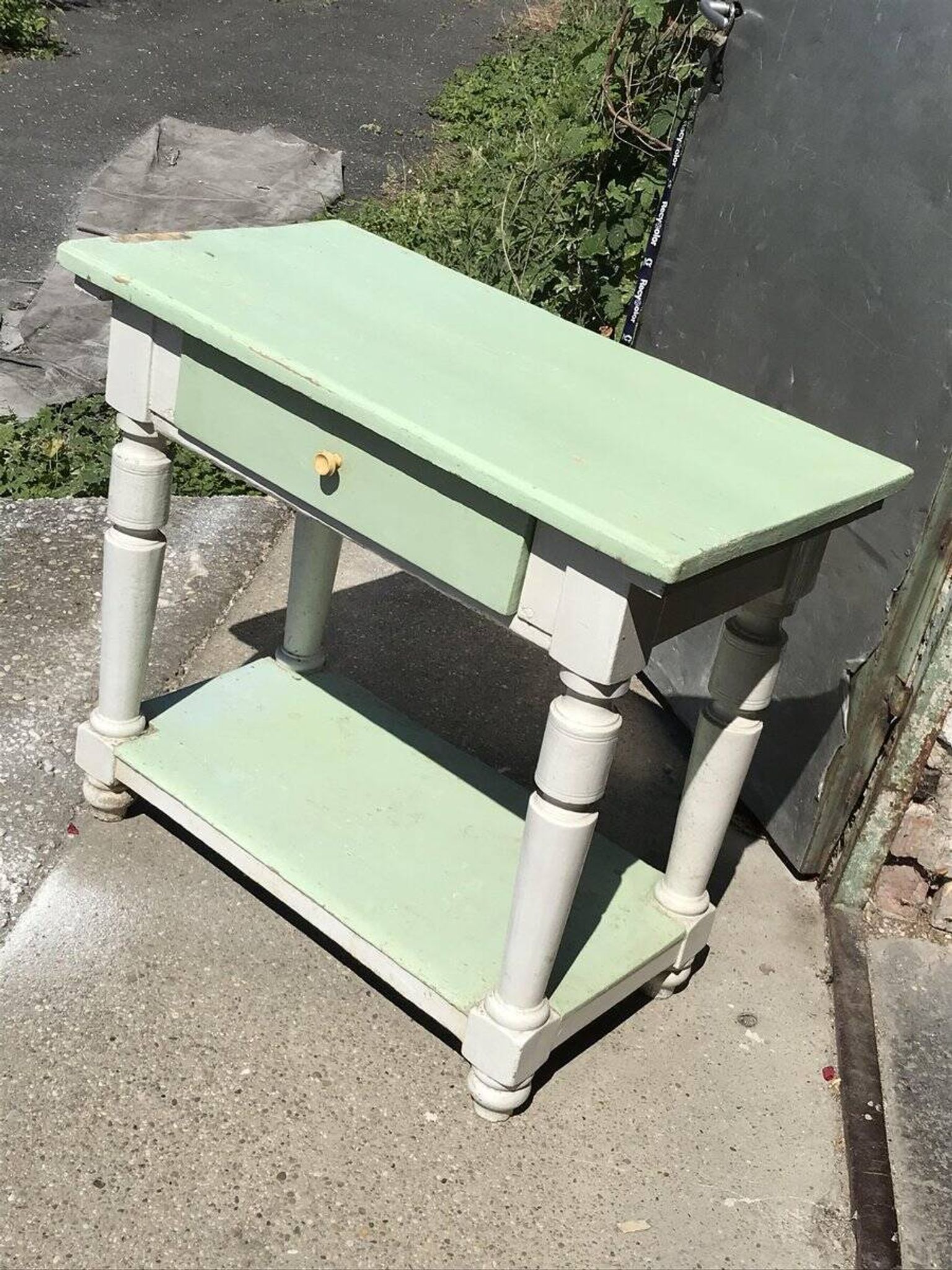 Rustic wooden dining table painted white and pale green, with a central drawer, 1950s.