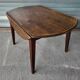 Antique round farmhouse table with drop-leaf doors in solid pegged wood
