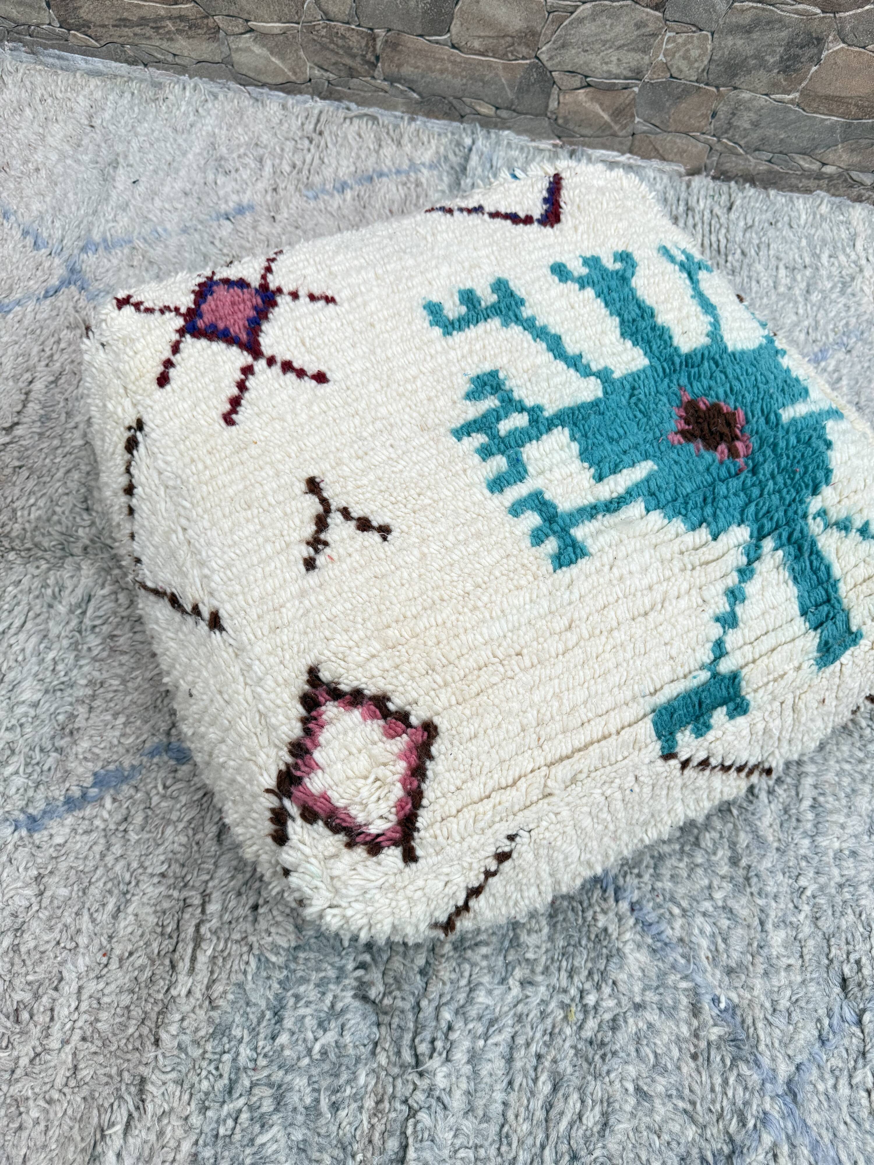 Berber floor pouf: Handwoven Moroccan wool cushion.