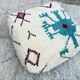 Berber floor pouf: Handwoven Moroccan wool cushion.