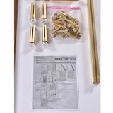 Tension pole free standing rose gold aluminum Omni wall unit by George Nelson