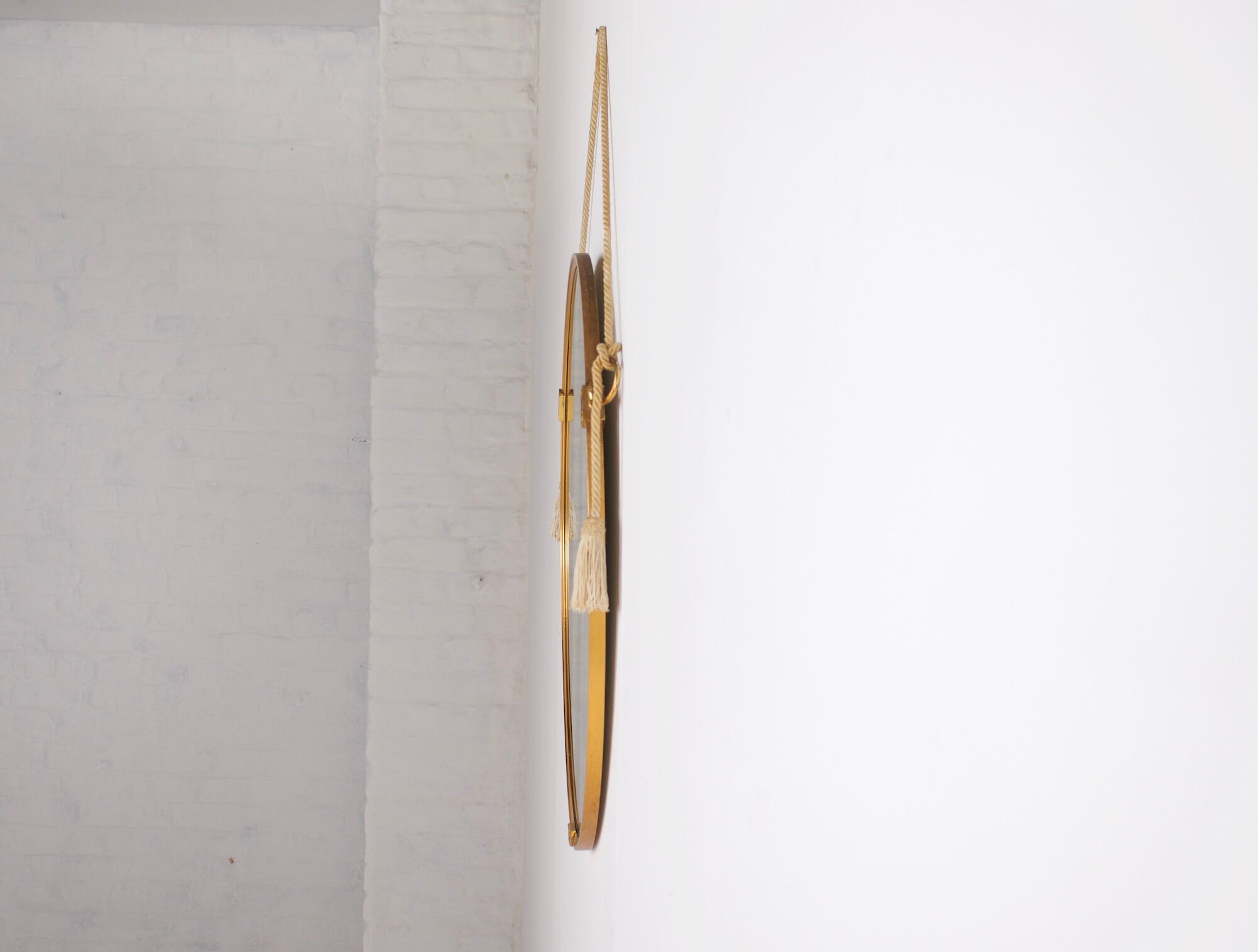 Hanging mirror in gilded brass