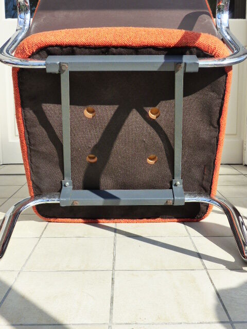 The 1970s orange armchair fabric and chrome metal