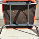 The 1970s orange armchair fabric and chrome metal