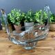 Thick glass centrepiece with raised handles in vintage design.