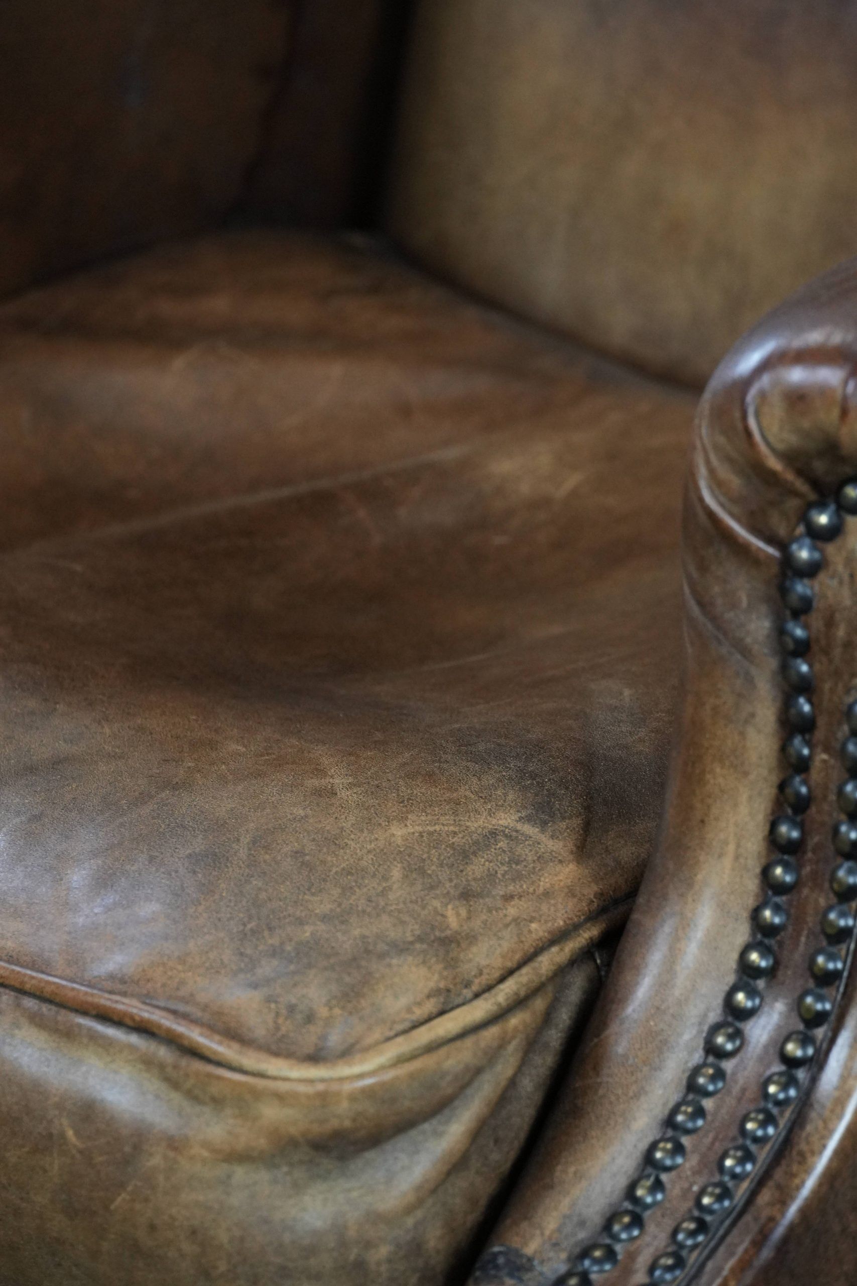 Warm, cosy and comfortable vintage sheepskin ear armchair with character