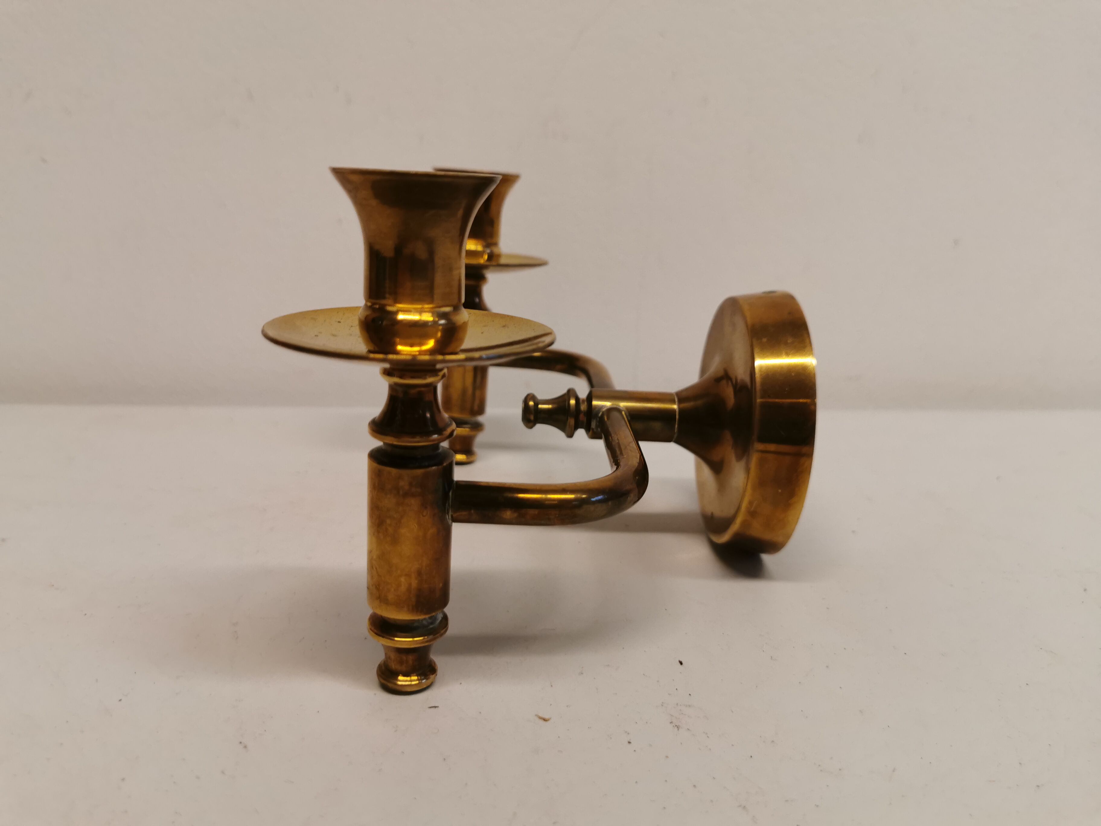 Classic Danish wall hung design candlestick in solid brass