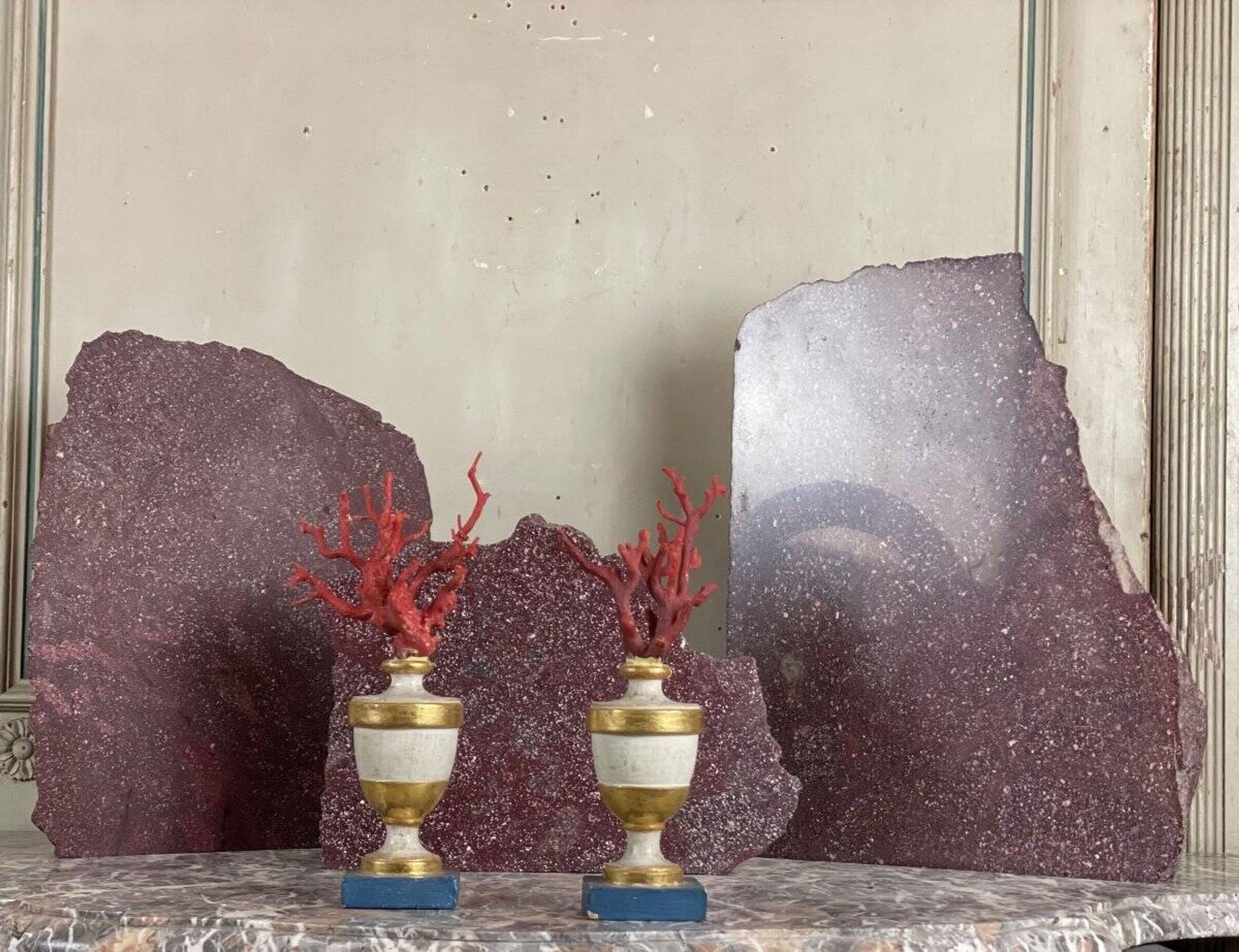 Pair of red corals on gilded and blue wooden bases