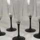 Set of 6 Octime champagne flutes in glass with black stem.