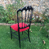 4 black reception chairs with red seats