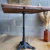 Bistro table with central cast iron leg and rustic top