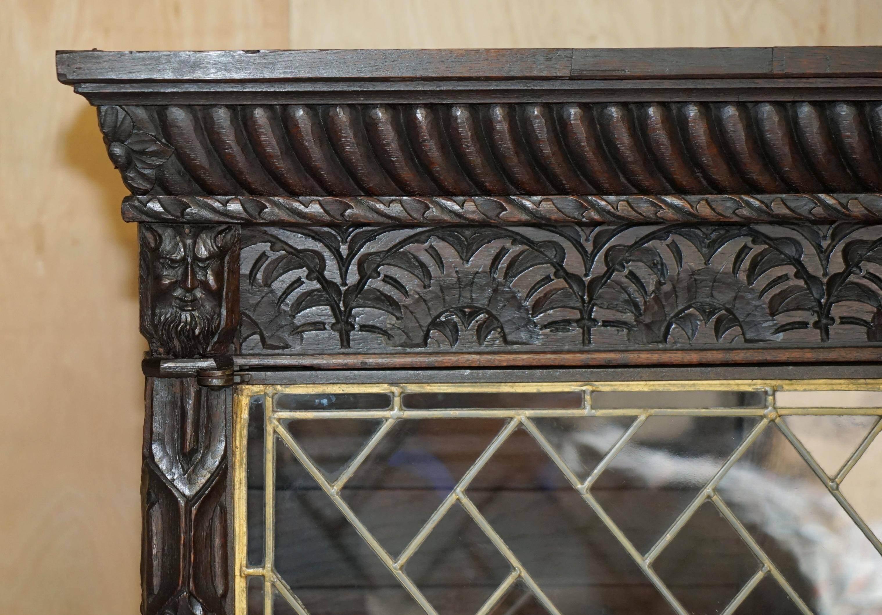 Jacobean hardwood library with carved panels and glass doors.