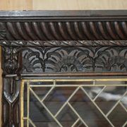 Jacobean hardwood library with carved panels and glass doors.