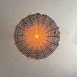 Large lampshade made of woven ropes.