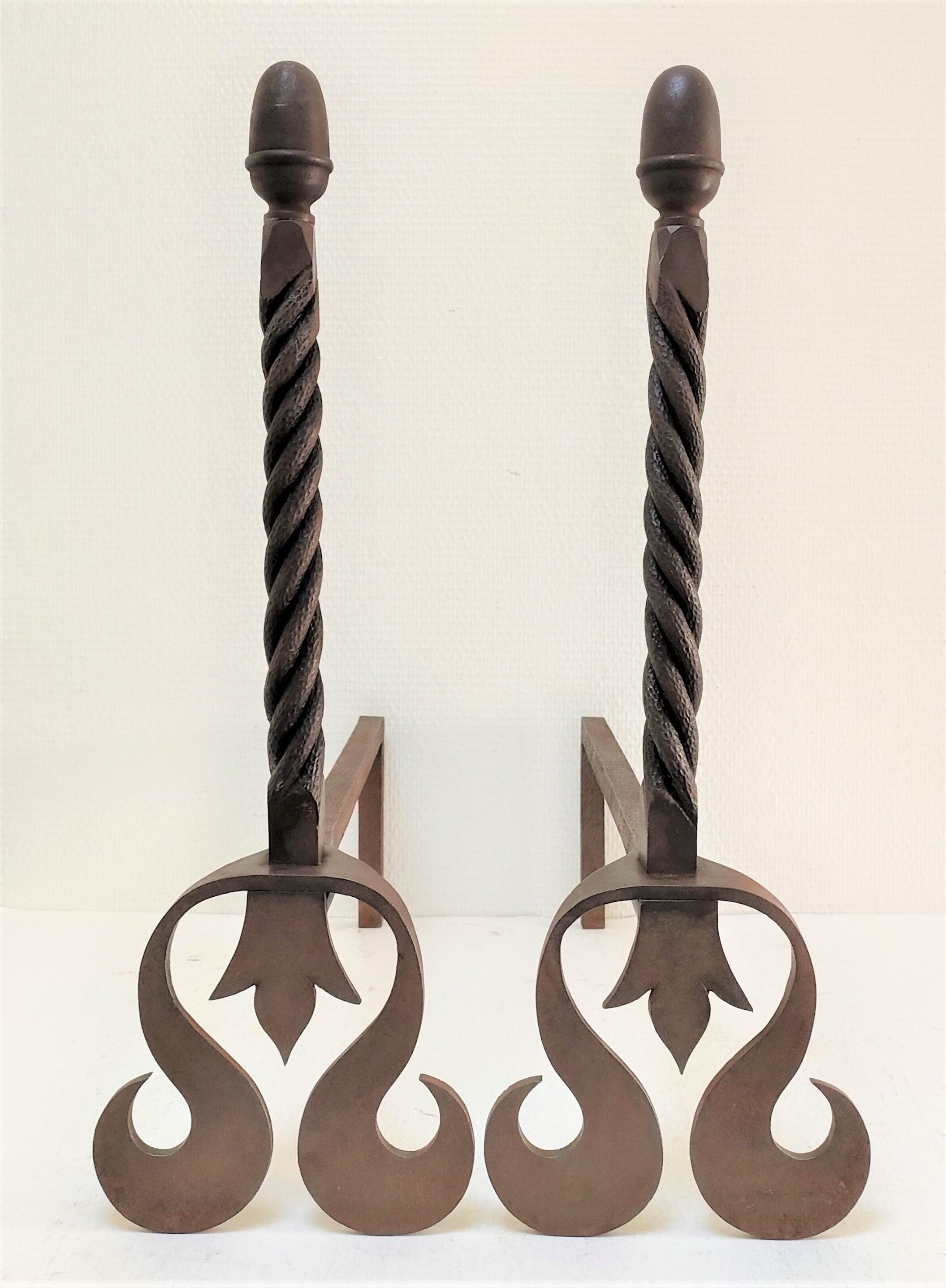 Pair of sculptural cast iron chenets with twisted heads