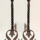 Pair of sculptural cast iron chenets with twisted heads