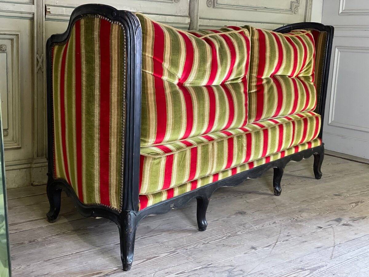 Louis XV style sofa in carved wood with a black patina