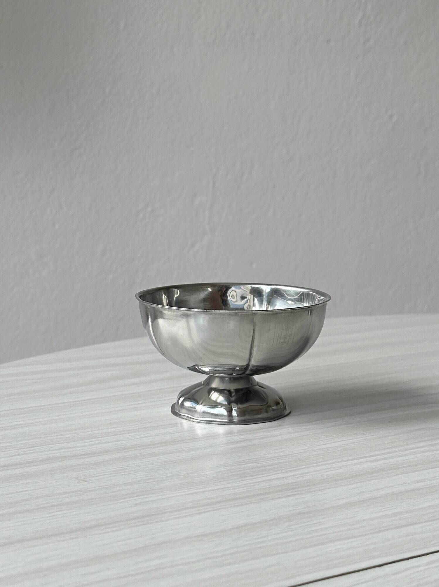 Set of 6 silver stainless steel ice cream bowls on a stand.