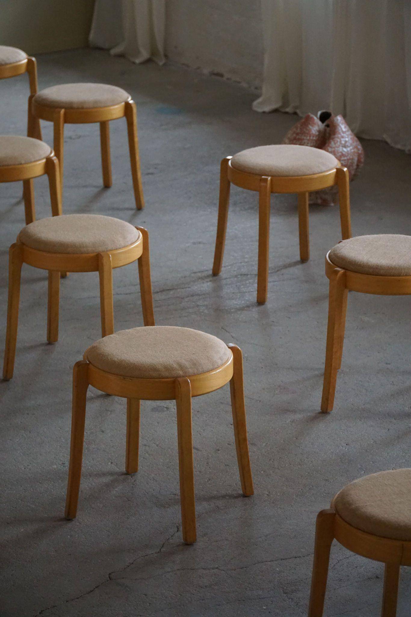Set of 14 modern Swedish stackable stools in birch and hessian, 1980s.
