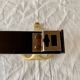 Vintage coat rack in lacquered metal with three golden aluminum hooks