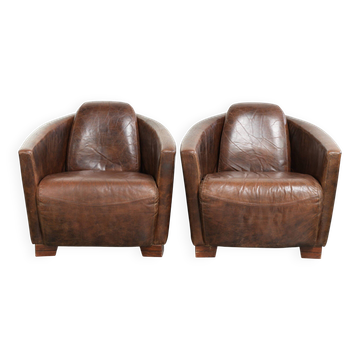 Set of 2 cowhide Aviator design armchairs in a warm brown colour