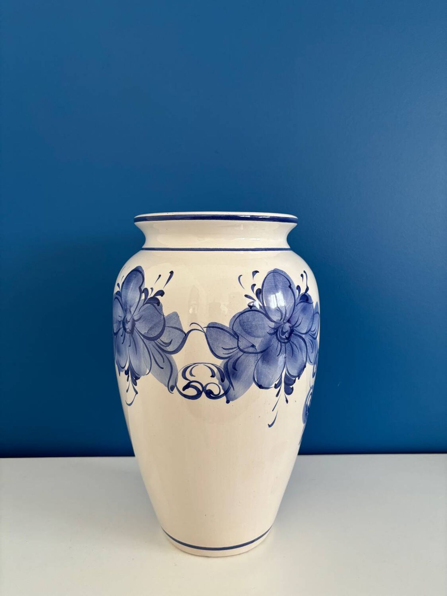 Vintage white and blue ceramic vase with floral pattern