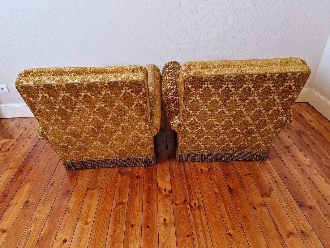 Pair of golden fringed armchairs