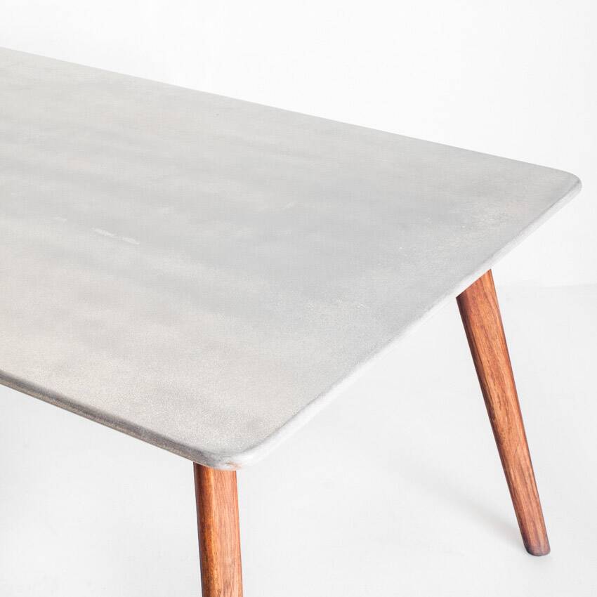 Scandinavian style dining table. Polished and varnished wood and concrete. For indoor or outdoor use.