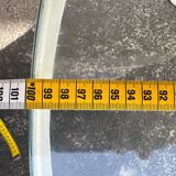 Round coffee table with a metal/leather frame and glass top by Roche Bobois.