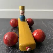 Vintage wooden pull toy, yellow car and small soldier.