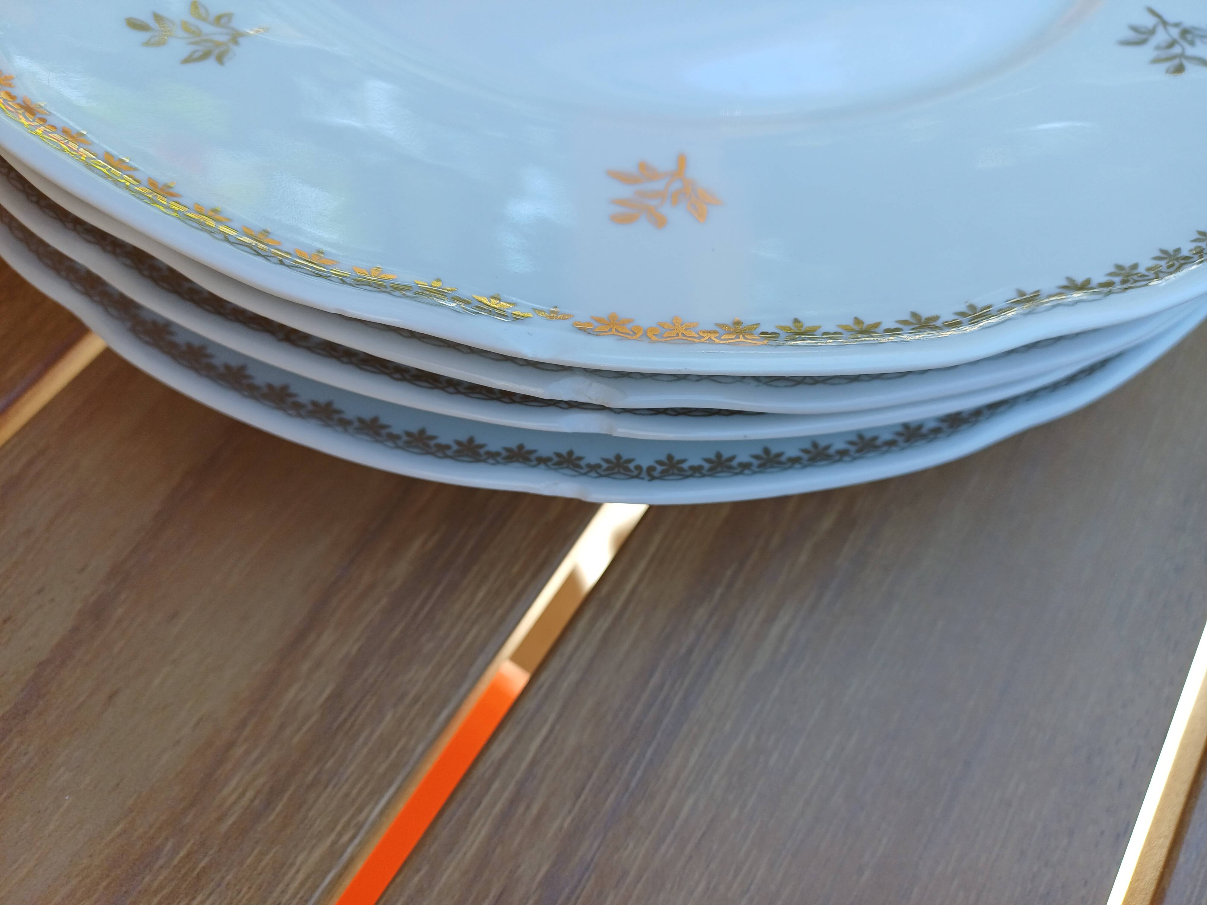 A lot of old white and gold porcelain plates T de F.