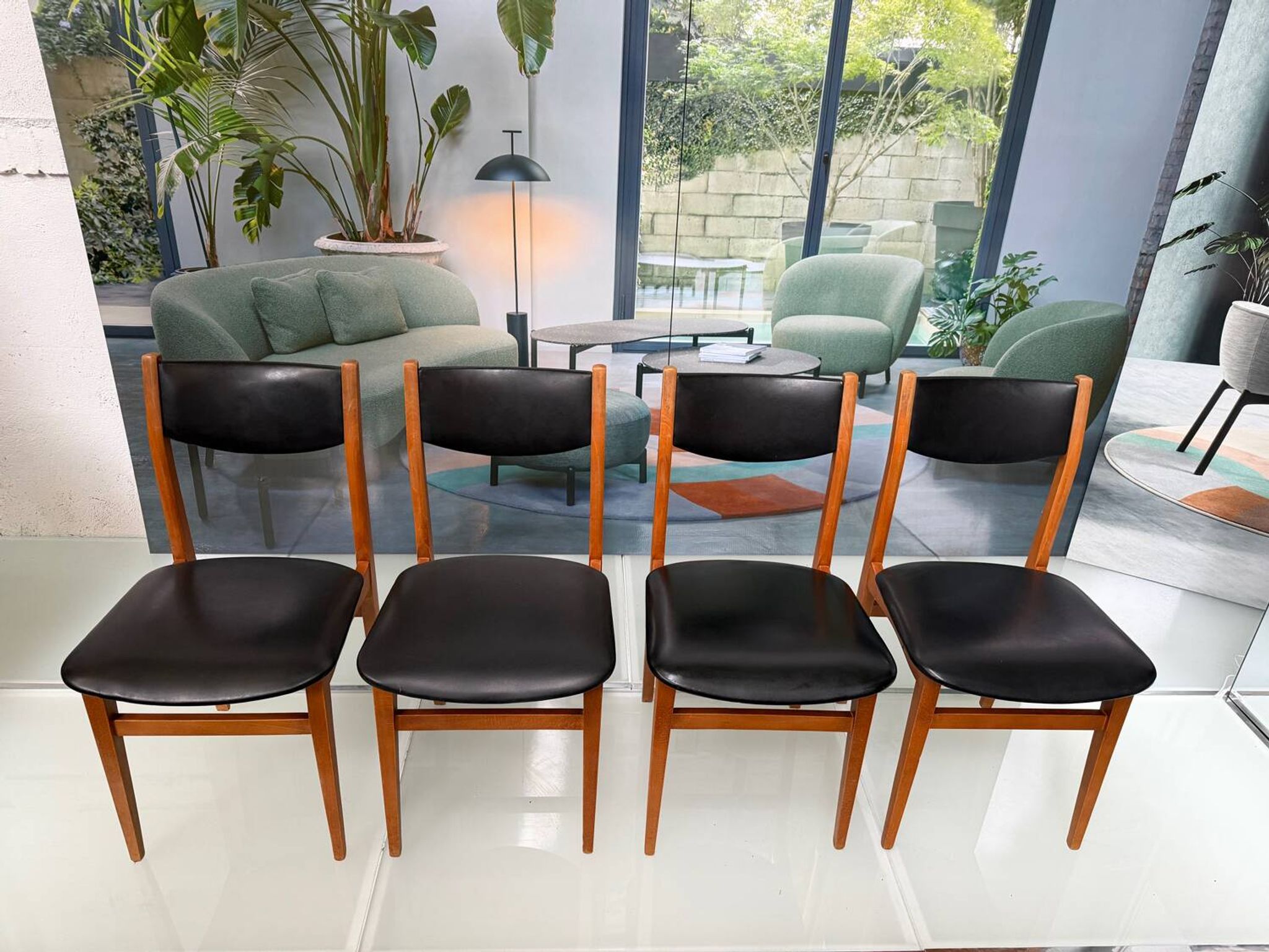 4 Scandinavian chairs in teak and black faux leather.