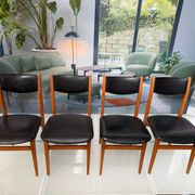 4 Scandinavian chairs in teak and black faux leather.