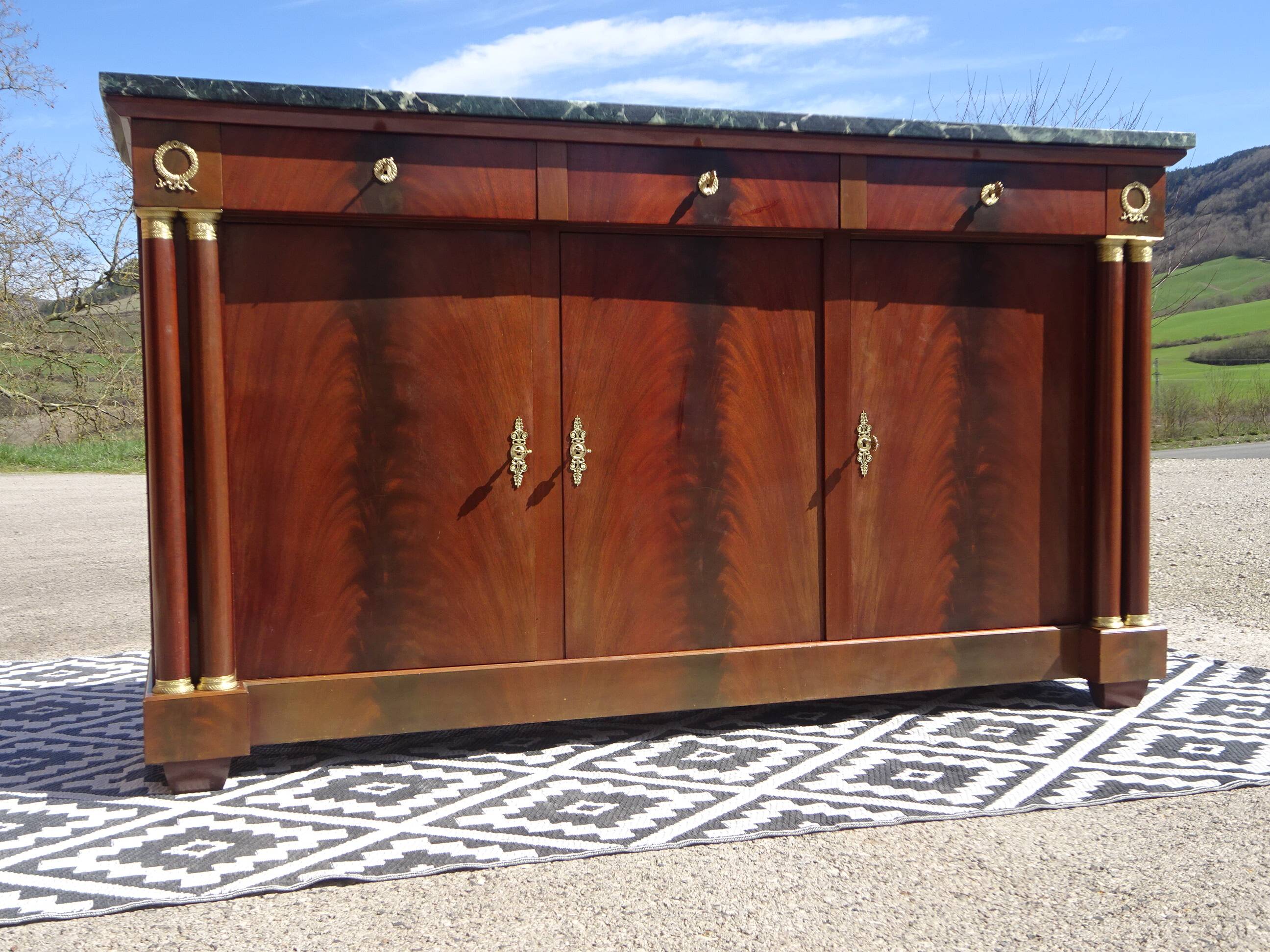 Flamed mahogany enfilade with sea green marble in Empire style.