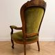 Antique armchair in olive green velvet and carved wood.