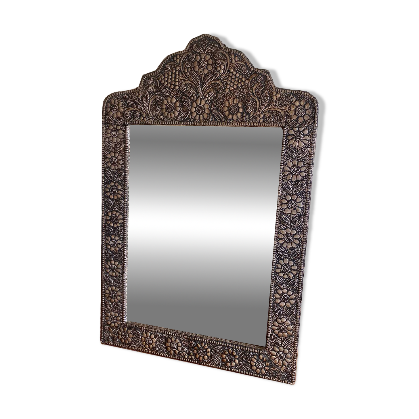 Ancient oriental mirror in embossed copper