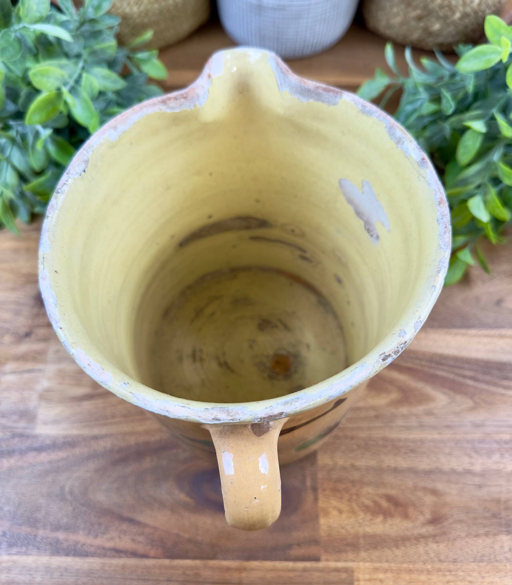 Large vintage ceramic pitcher with abstract green and brown decoration.