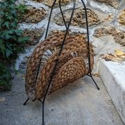 Vintage metal and wicker magazine rack, bohemian country decor.