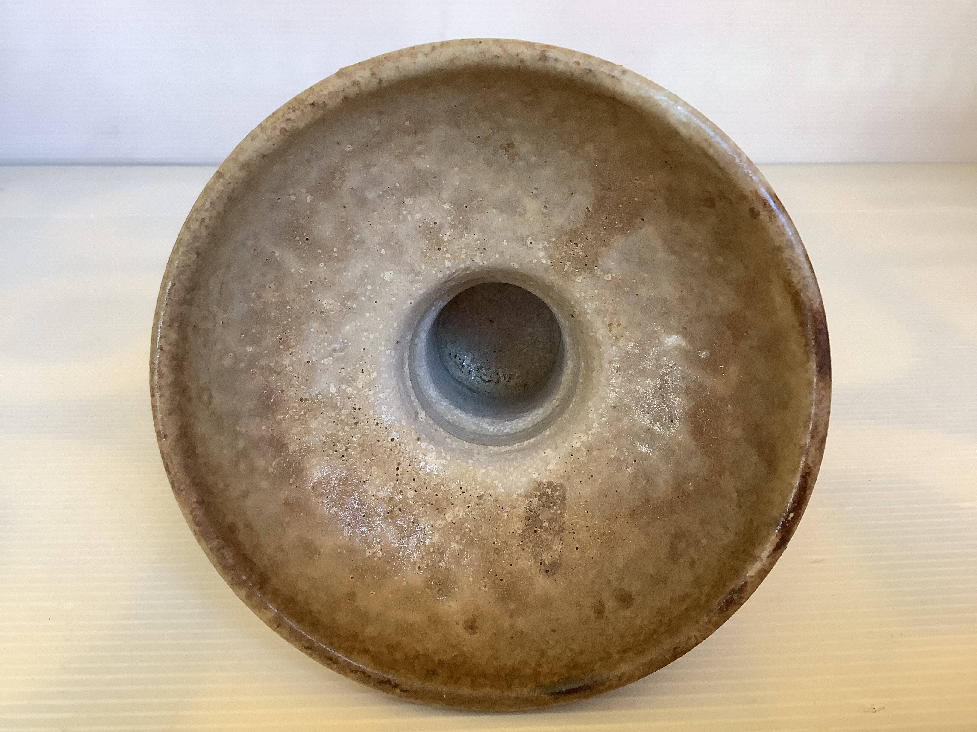 Beige ceramic chalice-shaped candle holder