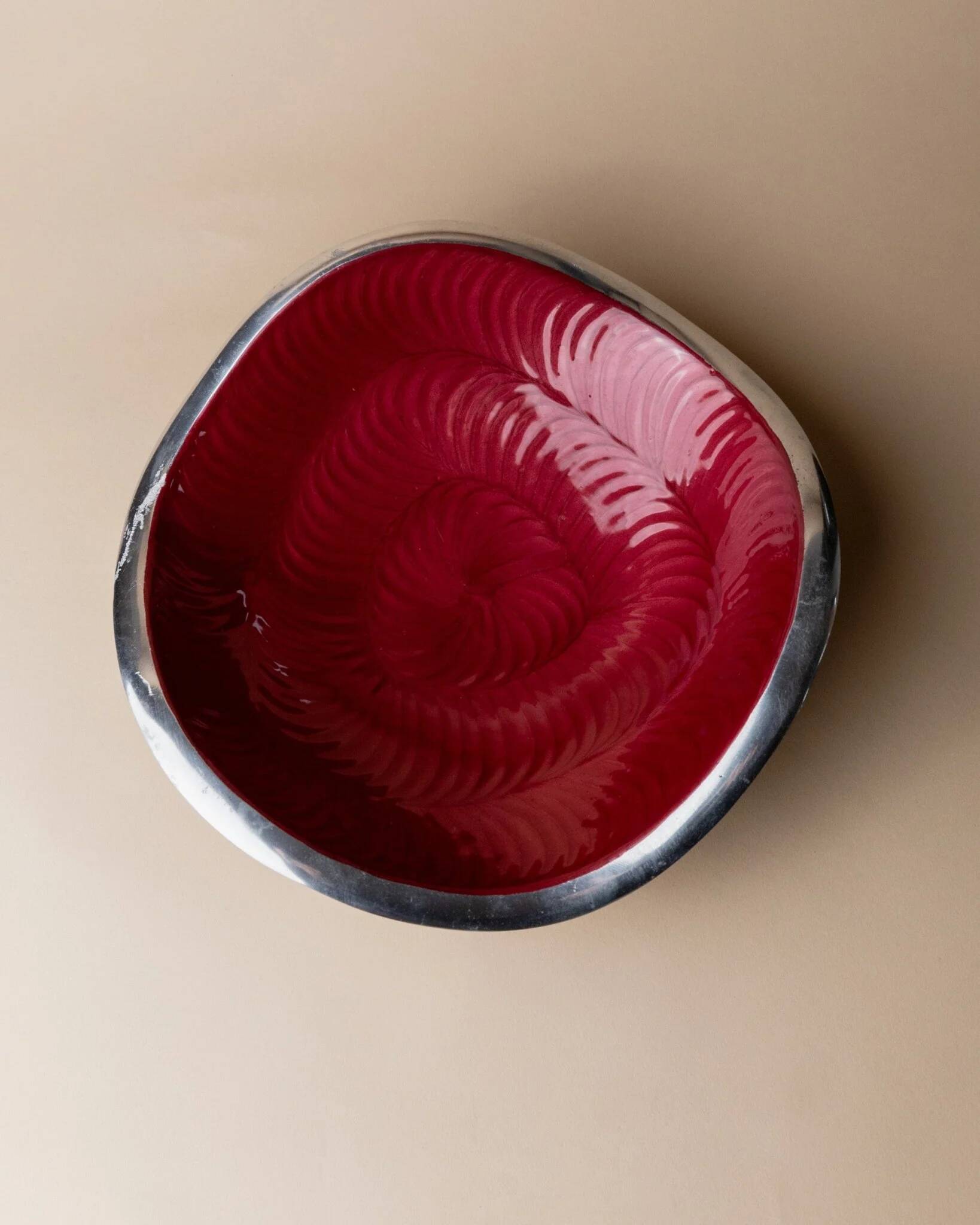 Red enameled steel bowl with textured interior and silver exterior; vintage Italian 1970s design