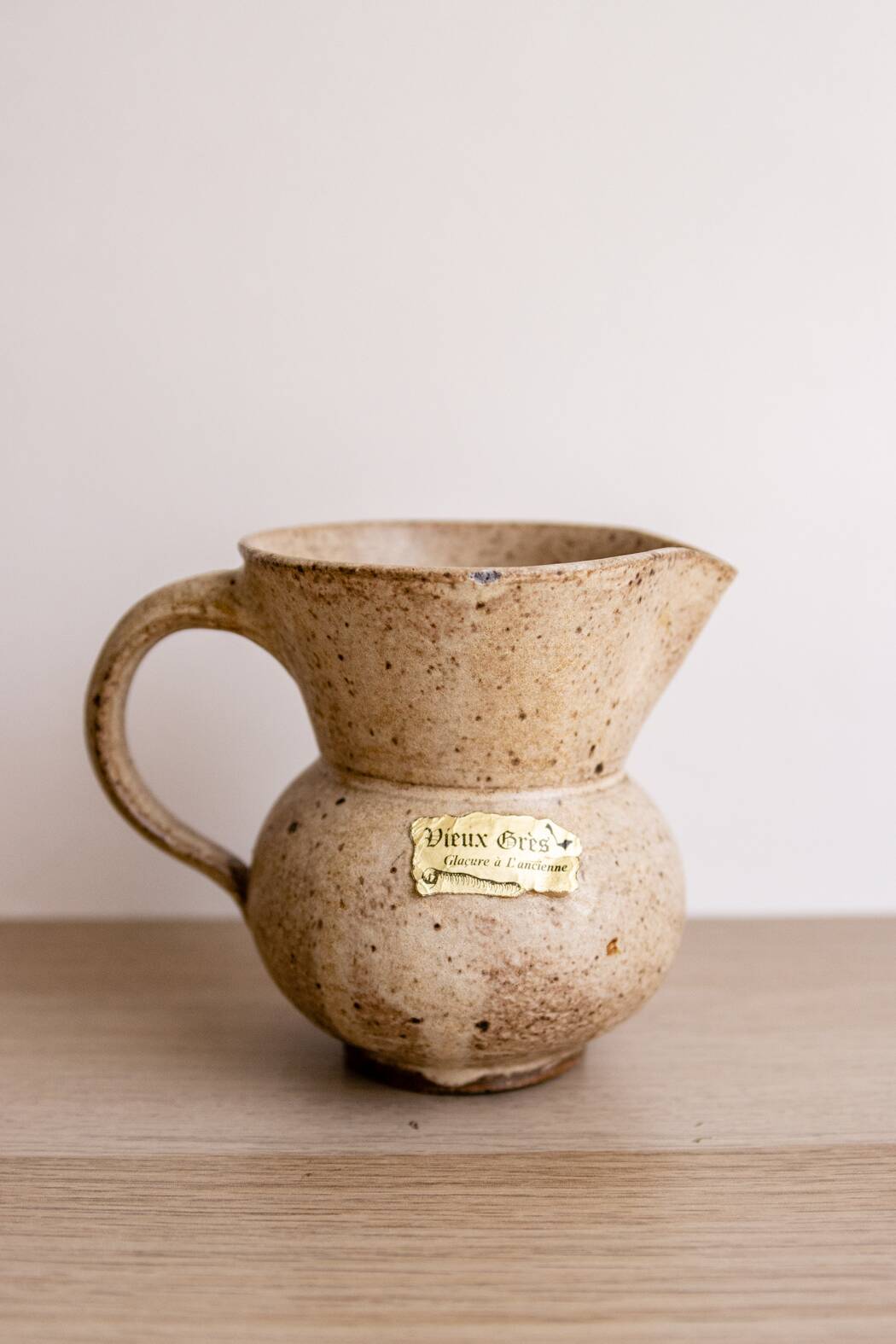 Small pitcher in old speckled stoneware