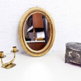 Golden oval mirror