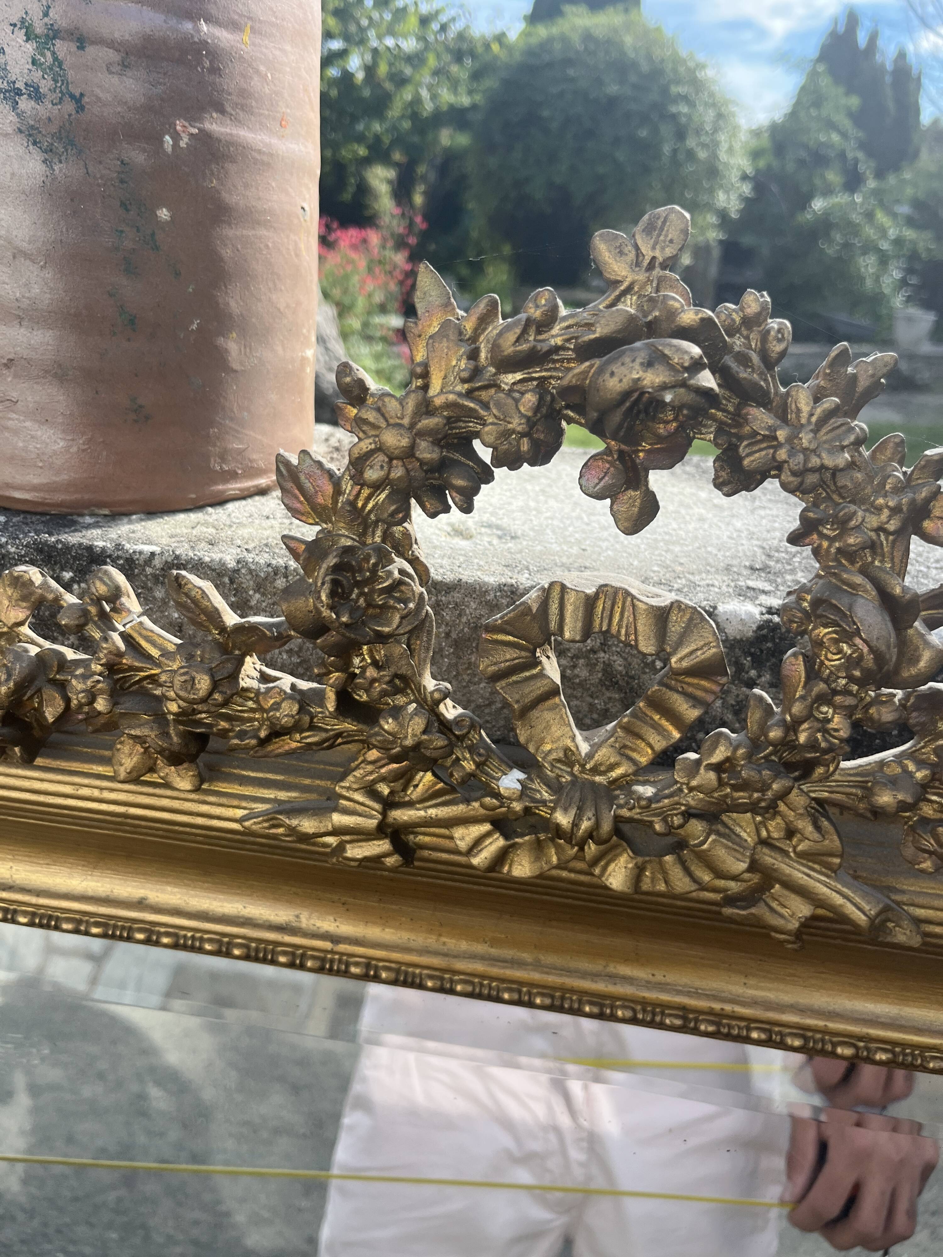Large antique gilded mirror with carved pediment, 126 cm