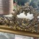 Large antique gilded mirror with carved pediment, 126 cm