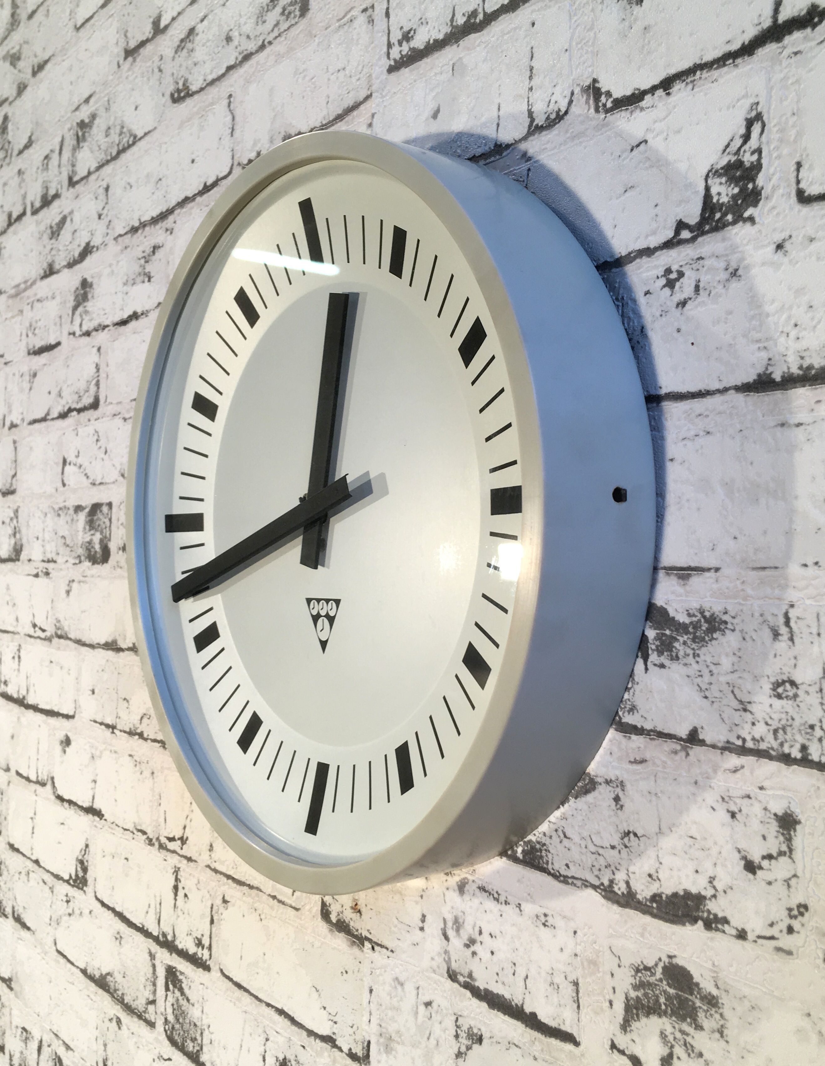 Grey industrial bakelite office wall clock from Pragotron, 1970