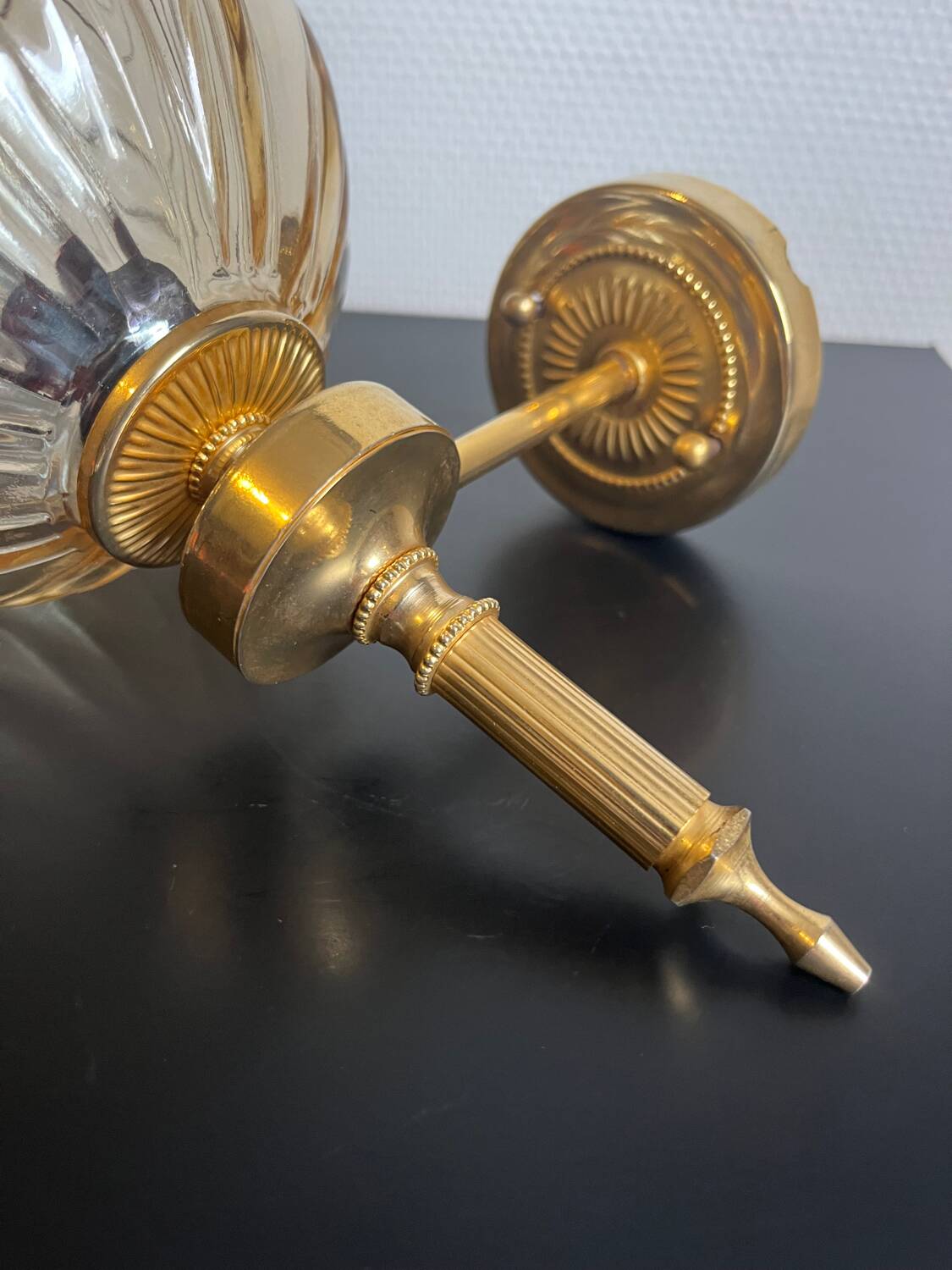 Brass wall light and bubbled glass globe