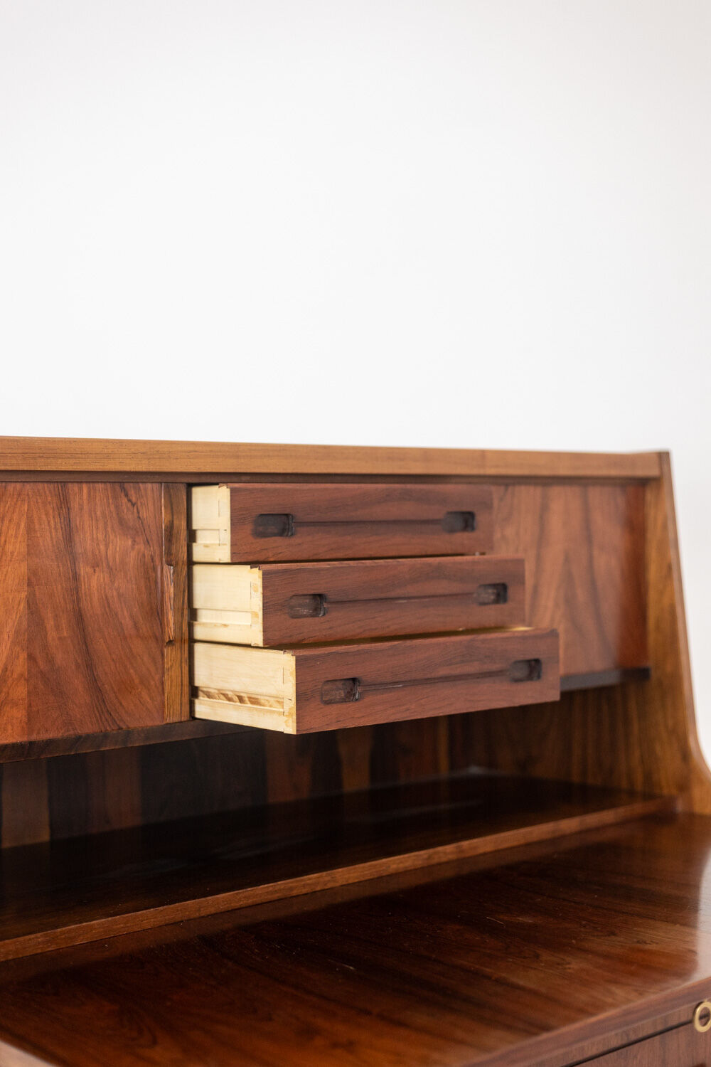 Rosewood chest of drawers with 2 drawers, forming a secretary. 1970s.