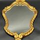 Miroir style baroque – bois doré sculpté – volutes et coquille
